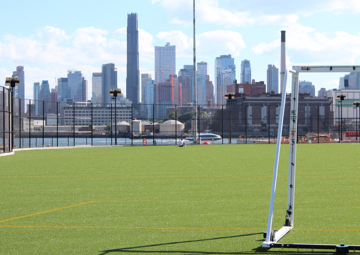 Reconstructed multi-use ballfield in East River Park overlooks the Manhattan skyline.